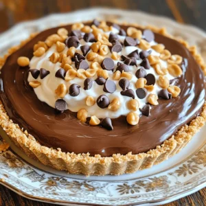 - 1 ½ cups chocolate graham cracker crumbs - ½ cup unsalted butter, melted - 1 cup creamy peanut butter - 1 cup powdered sugar - 8 oz cream cheese, softened to room temperature - 1 ½ cups whipped cream (or whipped topping) - ½ cup chocolate chips (for garnish) - Chopped peanuts (for garnish) Serving size for this pie is about 8-10 slices. If you need more or less, just adjust the ingredients. For example, double everything for a bigger pie. For the crust, you can swap chocolate graham crackers with regular graham crackers. This will change the flavor a bit but will still taste great. If you want a nut-free option, use crushed cookies instead. If you cannot find creamy peanut butter, try crunchy peanut butter. It adds a fun texture. You can also use almond or cashew butter for a different taste. If you need a dairy-free option, use a non-dairy cream cheese and whipped topping. Just check the labels to ensure they fit your needs. These simple swaps can help you make the pie your own while keeping it delicious! To make the chocolate graham cracker crust, start by mixing the crumbs and melted butter. In a medium bowl, combine 1 ½ cups of chocolate graham cracker crumbs with ½ cup of melted unsalted butter. Stir until it looks like wet sand. This step is key for a great crust. Next, press the mixture into a 9-inch pie dish. Make sure to cover the bottom and up the sides evenly. Use the back of a measuring cup to help you press it down flat. This helps the crust hold together. Chill the crust in the fridge for about 10 minutes. This will firm it up nicely. For the filling, mix 1 cup of creamy peanut butter with 8 oz of softened cream cheese. Use an electric mixer to beat them until smooth. This will create a creamy base for your pie. Next, sift in 1 cup of powdered sugar while mixing. This adds sweetness and makes the filling rich. After that, gently fold in 1 ½ cups of whipped cream. This gives the filling a light, airy texture. Be careful not to deflate the whipped cream; it should stay fluffy. Now it’s time to pour the filling into the chilled crust. Spread it evenly using a spatula. Make sure the top is smooth and nice. This step is important for a beautiful pie. After assembling, return the pie to the fridge. Chill it for at least 2 hours. This helps the filling set properly. When it is firm, your pie will be ready to slice and enjoy! - Overmixing the filling: When you mix the peanut butter and cream cheese, stop when it's smooth. Overmixing can make it too dense. - Not chilling the pie long enough: Be patient! Let the pie chill for at least two hours. This helps the filling set properly. - Tips for making the filling fluffier: Fold the whipped cream gently into the peanut butter mixture. This keeps the filling light and airy. - Serving suggestions for paired toppings: Try adding a drizzle of melted chocolate or a dollop of whipped cream on top. Chopped peanuts also add a nice crunch. - Creative ways to garnish the pie: Sprinkle chocolate chips and chopped peanuts on top. You can also add fresh berries for color. - Plate arrangements for stunning visuals: Serve slices on colorful dessert plates. Drizzle chocolate sauce around the plate for an extra touch. {{image_4}} You can create fun twists on this pie. Try different types of chocolate, like dark or white chocolate. Each type adds a new flavor. You can also substitute peanut butter with almond or cashew butter. This gives the pie a nice nutty taste. Explore these options to find your favorite! Want a vegan pie? Use plant-based cream cheese and whipped topping. Make sure your crust is vegan too. You can use coconut oil instead of butter. For a gluten-free version, swap chocolate graham crackers with gluten-free crumbs. These changes keep the pie tasty and friendly for various diets. Mini no-bake pies are easy to make! Use muffin tins or small jars. This way, each person gets their own pie. You can also turn the pie into parfaits. Layer the filling and crust in glasses for a fun presentation. This makes a great treat for parties or gatherings! To keep your Chocolate Peanut Butter No-Bake Pie fresh, store it in the fridge. Cover it tightly with plastic wrap or foil. This prevents it from absorbing other smells and flavors. If you want to save it longer, you can freeze it. Cut the pie into slices, wrap each piece in plastic, then place them in a freezer-safe bag. This method keeps the pie tasty for later enjoyment. In the fridge, this pie lasts about 4 to 5 days. Always check for signs of spoilage. If the pie looks dry or has an off smell, it’s best to toss it. Mold is another clear sign that the pie is no longer good. When you see these signs, do not eat it. When you’re ready to enjoy your stored pie, thaw it in the fridge overnight. This keeps the texture nice. If you’ve frozen slices, let them sit at room temperature for about 15 minutes before eating. To refresh the pie, add a dollop of whipped cream on top. This makes it look fresh and tasty! The pie needs to chill for at least 2 hours. This allows the filling to firm up nicely. I recommend checking it after this time. If it feels soft, give it more time. Yes, you can use crunchy peanut butter. This will add a nice texture to the pie. It gives little bites of peanut that add fun. The flavor remains rich and nutty, which I love. Cream cheese is important for a creamy texture. However, you can swap it with Greek yogurt or silken tofu. These options will change the taste slightly. They can still keep the pie smooth and delicious. You can definitely add more chocolate! Try adding chocolate syrup or more chocolate chips. Just be careful not to add too much. This can make the pie too heavy and change the texture. This blog post covered everything you need for a delicious no-bake peanut butter pie. We discussed the key ingredients, proper measurements, and tasty variations. I shared step-by-step instructions to guide you through the process and offered tips to avoid common mistakes. With some creativity, you can present this pie beautifully and store it properly. Enjoying this treat can be fun and easy. Now, it's time for you to gather your ingredients and start making your own pie masterpiece!